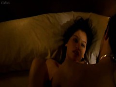 Laetitia Casta straddling a guy in bed, pulling her dress